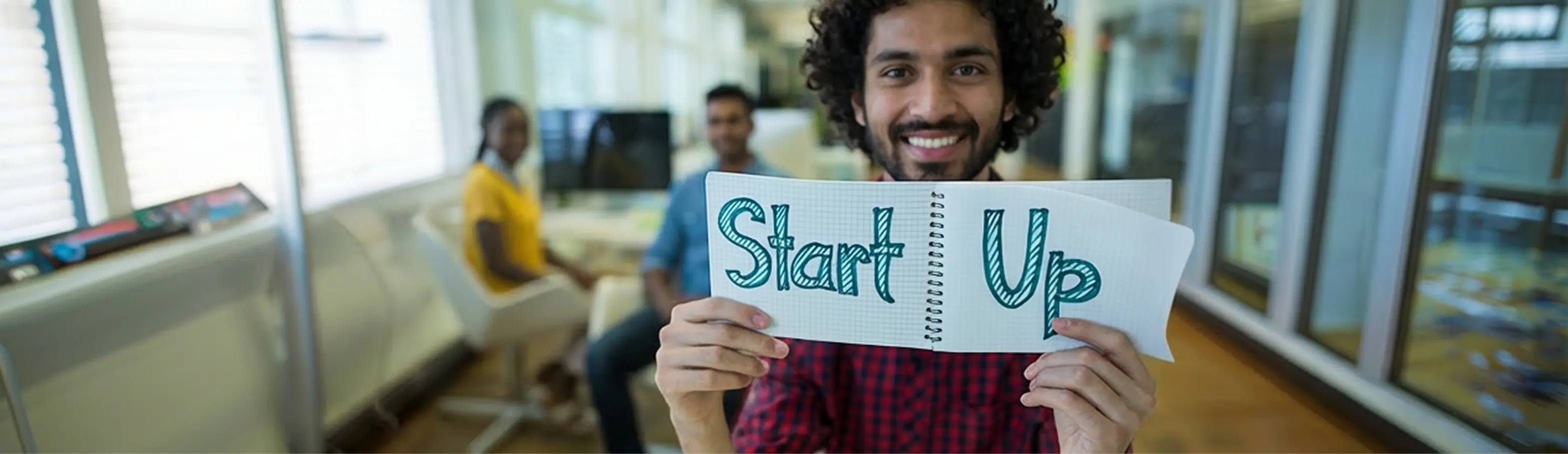 A person holding a notebook with a startup idea at an InspireSphere event